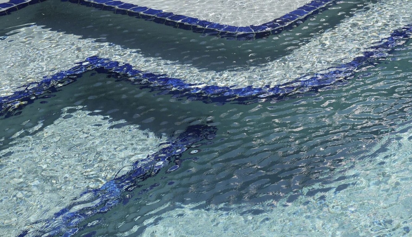 Clean pool tile after professional calcium scale removal service